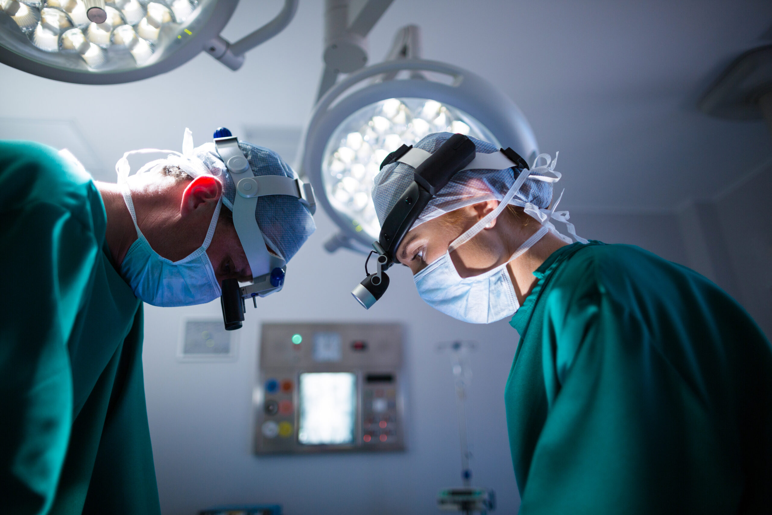 Surgeons wearing surgical loupes while performing operation in operation theater